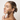 A model holds an ORMEDIC balancing eye lift gel against her neck and jawline. 